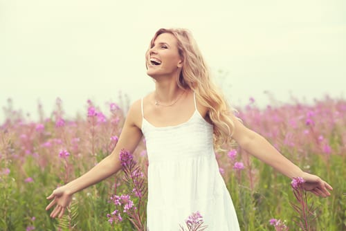Laughing woman in field of flowers